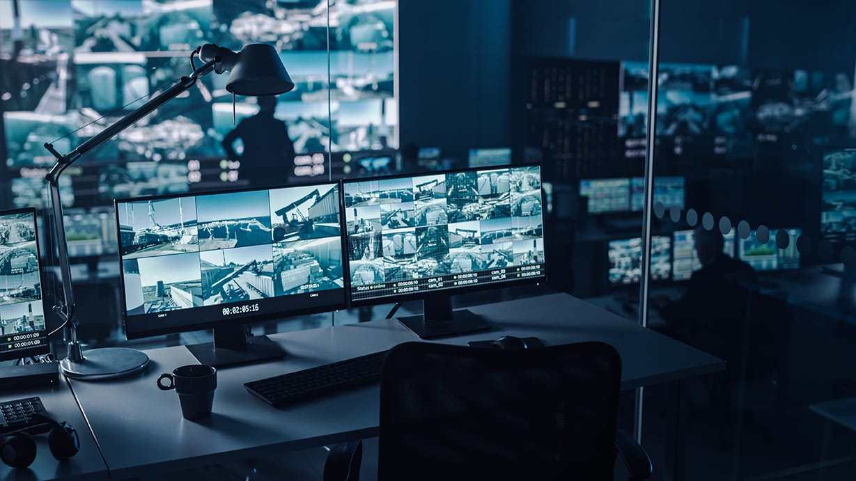 Two Digital Computer Screens with Surveillance CCTV Video in security center