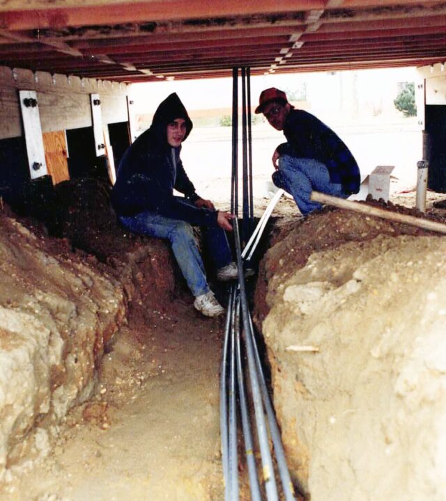 Two workers in a trench.